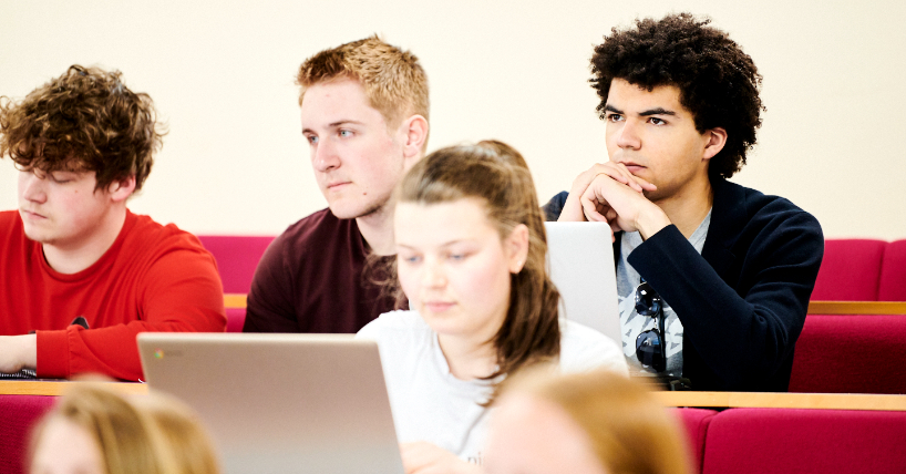 image of four students with laptops